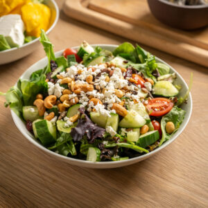 Made with spring mix, tomatoes, cucumbers, red bell peppers, raisins, dried cranberries, sunflower seeds and feta cheese. Served with a side of honey citrus dressing